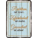 Schild Spruch "Reichtum ist viel, Zufriedenheit ist...
